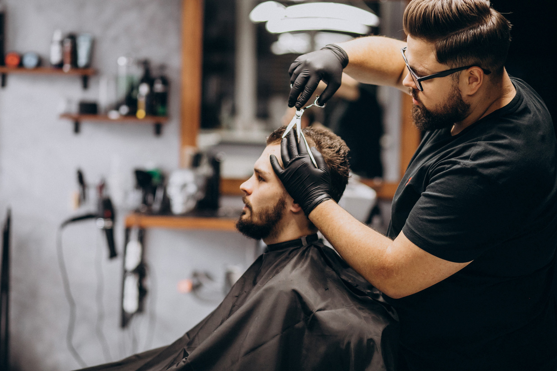 Barber cutting a client hair in a traditional shop